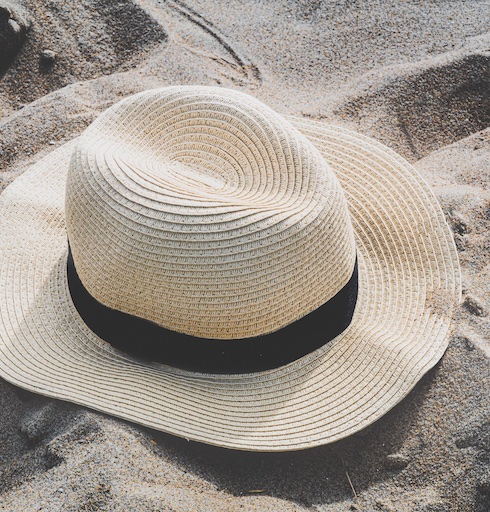 Erica-Wirka-MS-biography beach hat in the sand